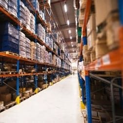 interior-of-large-distribution-warehouse-with-shelves-stacked-with-palettes-and-goods-ready-for-the-market